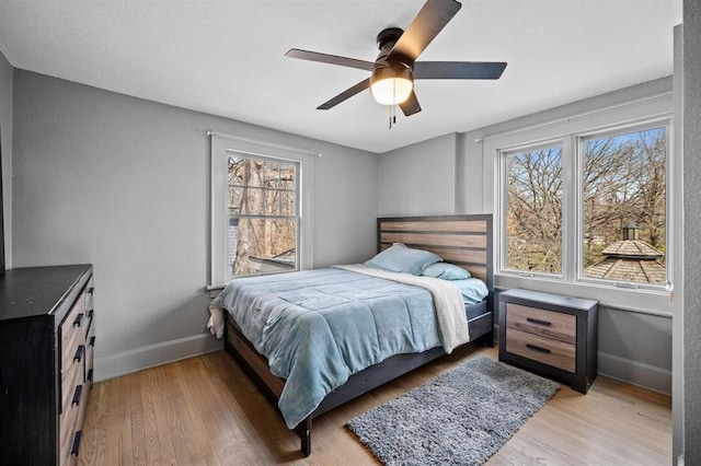 bedroom featuring ceiling fan and hardwood / wood-style flooring