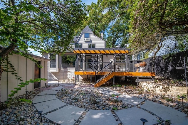 rear view of property with a pergola and a deck