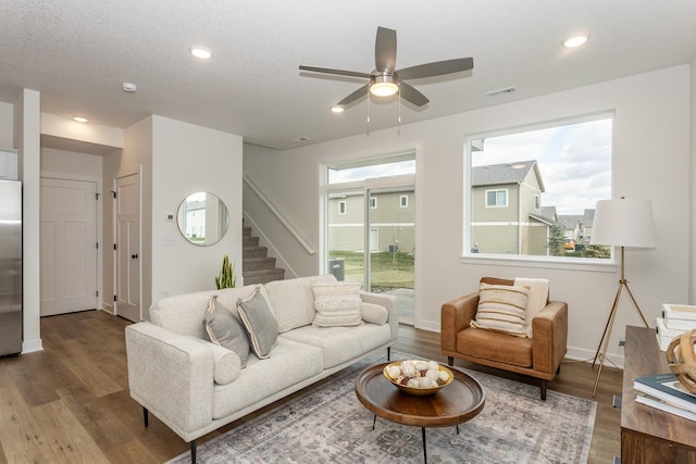 living room with hardwood / wood-style flooring, ceiling fan, and plenty of natural light