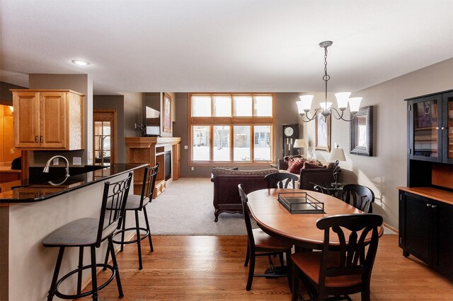 dining room with a chandelier and light hardwood / wood-style floors