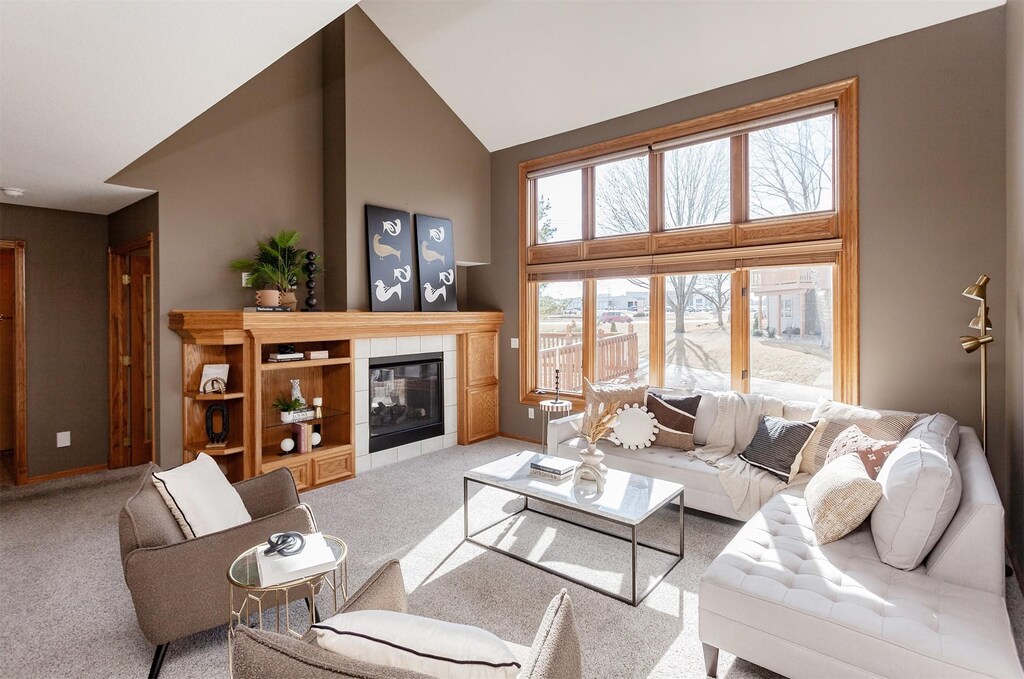 2382 NW 162nd Ln, Clive, IA 50325 - living area featuring carpet floors, high vaulted ceiling, and a tile fireplace