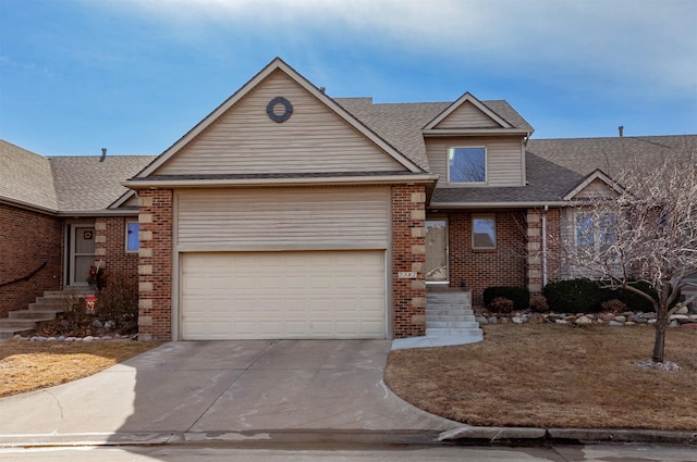 view of front of property featuring driveway, brick siding, an attached garage, and a shingled roof