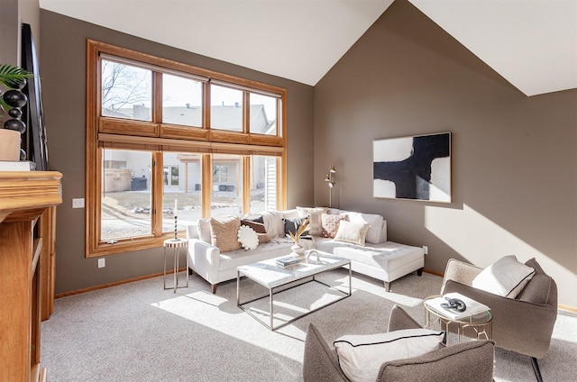 living area featuring light carpet, baseboards, and high vaulted ceiling