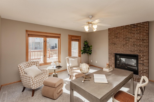 carpeted living room with a ceiling fan, a brick fireplace, and baseboards