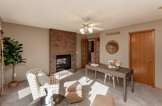 living area featuring baseboards, a fireplace, visible vents, and light colored carpet