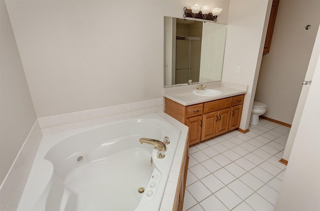 bathroom with tile patterned flooring, a jetted tub, toilet, and vanity