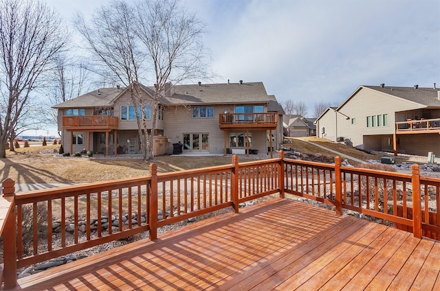 wooden deck featuring a residential view and a patio