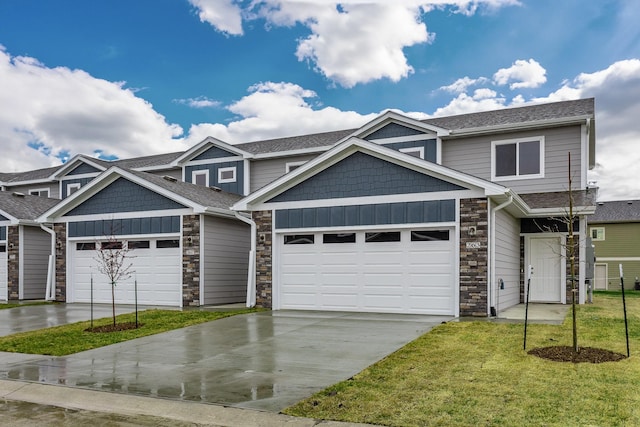 view of front facade with a garage, a shingled roof, a front lawn, and concrete driveway