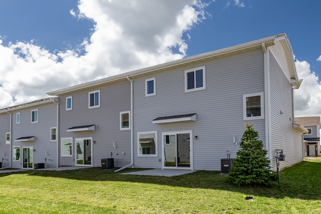 rear view of house featuring a yard, a patio, and central air condition unit