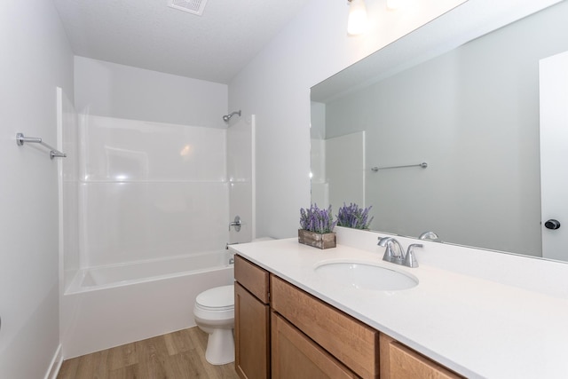 full bath featuring shower / tub combination, toilet, wood finished floors, visible vents, and vanity