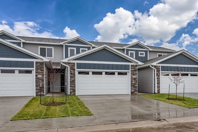 view of front facade with a garage, concrete driveway, a shingled roof, and board and batten siding