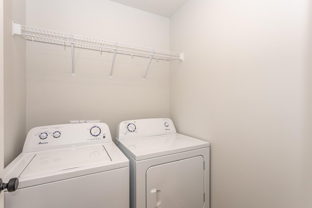 washroom featuring laundry area and washing machine and dryer