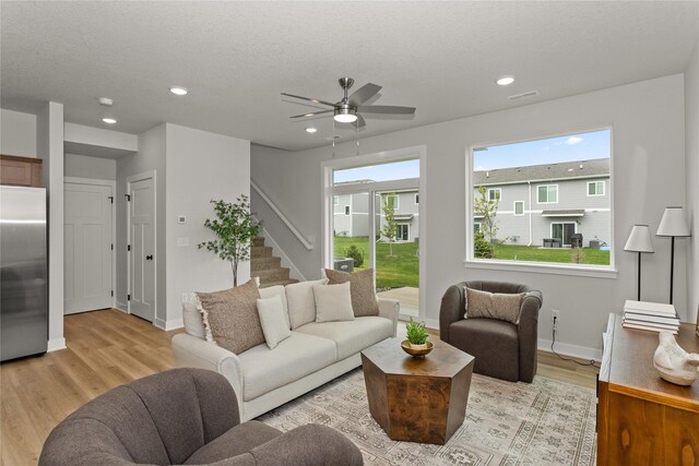 234 NW Waverly Dr, Waukee, IA 50263 - living area with light wood-style flooring, stairs, baseboards, ceiling fan, and recessed lighting