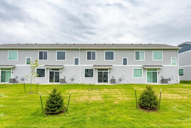 234 NW Waverly Dr, Waukee, IA 50263 - back of property featuring central AC and a yard
