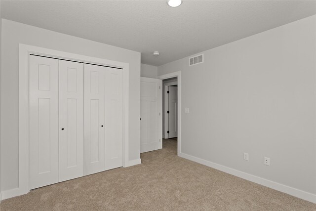 234 NW Waverly Dr, Waukee, IA 50263 - unfurnished bedroom with carpet floors, baseboards, and a closet