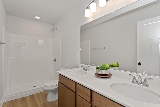 230 NW Waverly Dr, Waukee, IA 50263 - bathroom with toilet, wood finished floors, double vanity, and a shower