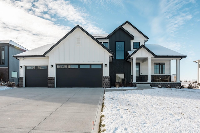 modern farmhouse style home with covered porch and a garage