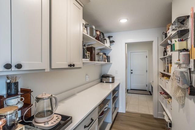 kitchen featuring white cabinets and dark wood-type flooring