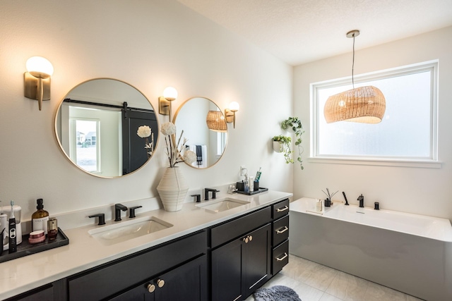 bathroom with a bathing tub, vanity, and a textured ceiling