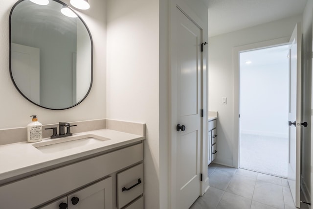 bathroom featuring tile patterned flooring and vanity