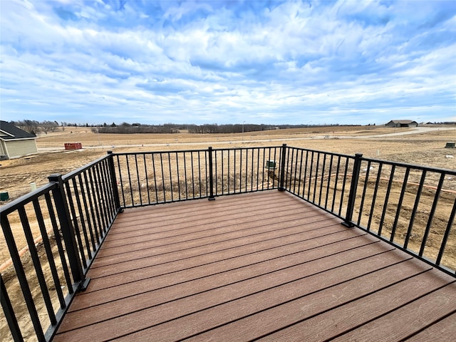 wooden terrace featuring a rural view