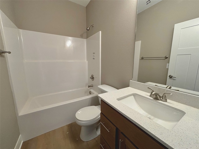 full bath with shower / bath combination, vanity, toilet, and wood finished floors