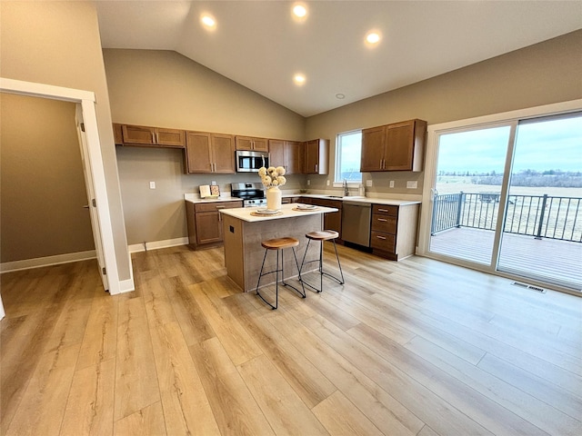 1677 20th Ave SE, Altoona, IA 50009 - kitchen with stainless steel appliances, a sink, a kitchen island, light countertops, and baseboards