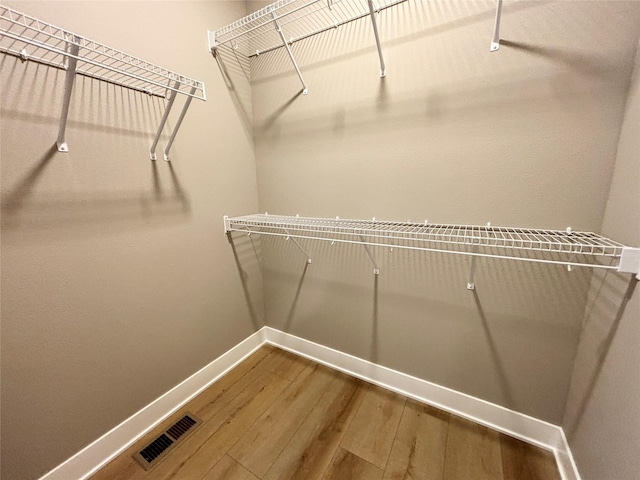 1677 20th Ave SE, Altoona, IA 50009 - walk in closet with hardwood / wood-style floors
