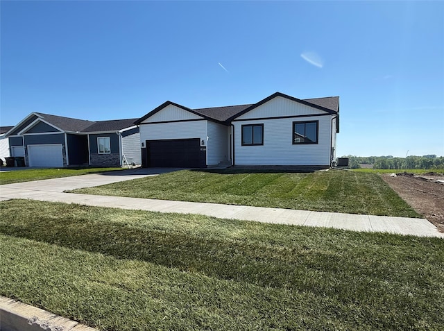 1677 20th Ave SE, Altoona, IA 50009 - single story home with concrete driveway, a garage, a front lawn, and central AC