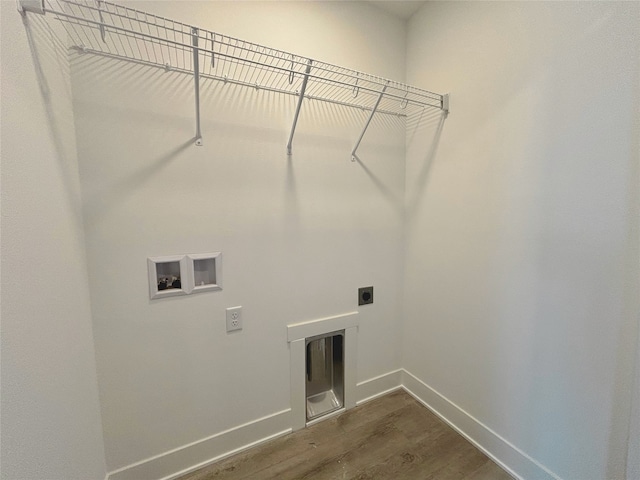 clothes washing area featuring hookup for a washing machine, dark wood-type flooring, hookup for an electric dryer, laundry area, and baseboards