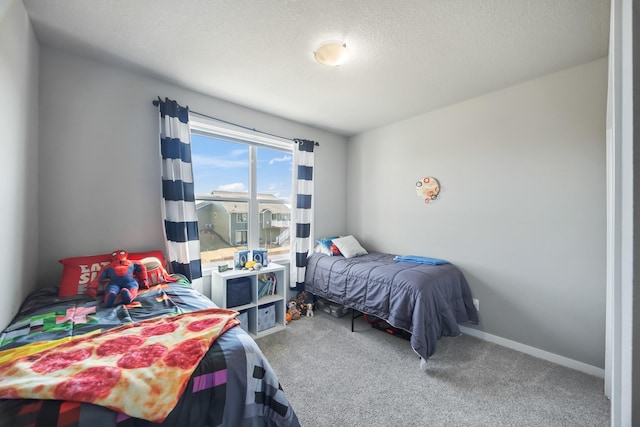 carpeted bedroom featuring a textured ceiling