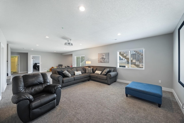 living room featuring carpet flooring and a textured ceiling