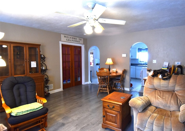 living room with ceiling fan, hardwood / wood-style floors, and sink