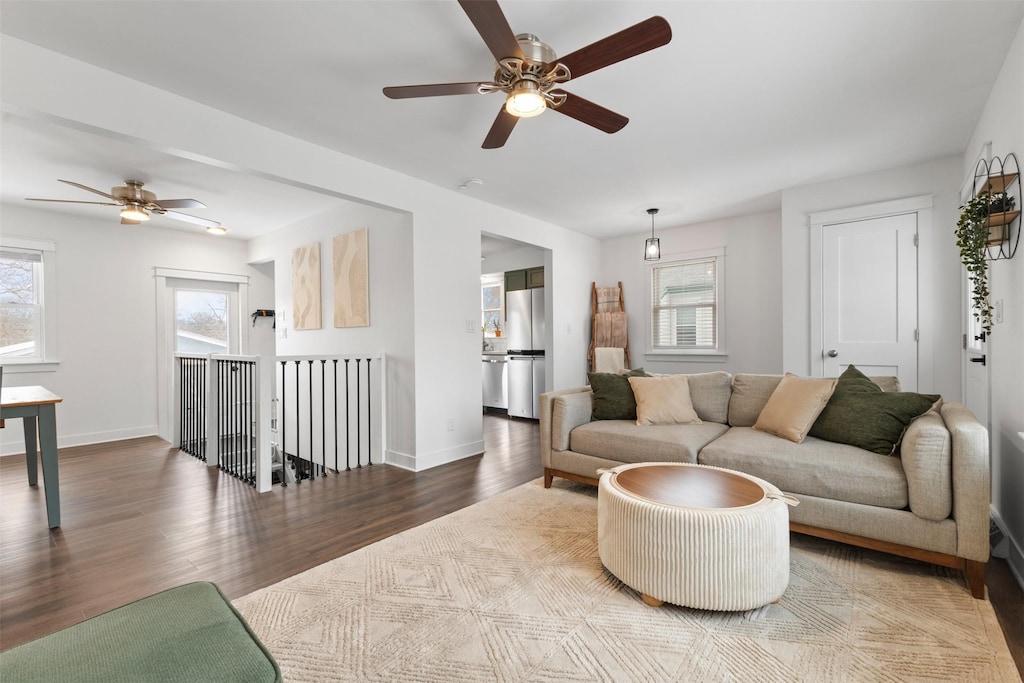 living room featuring hardwood / wood-style floors and ceiling fan