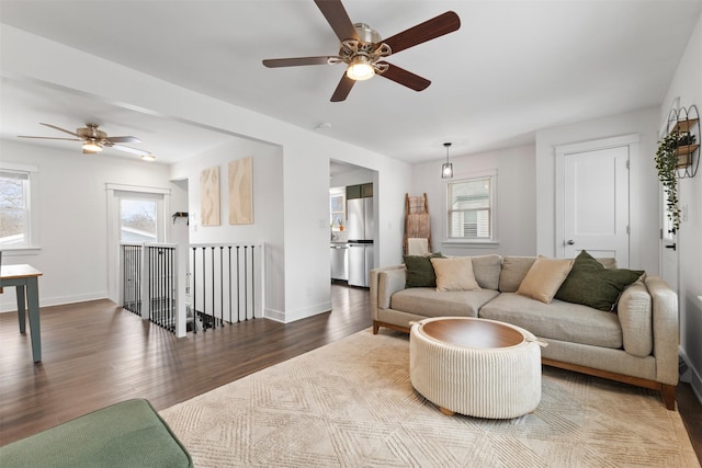 living room featuring hardwood / wood-style floors and ceiling fan