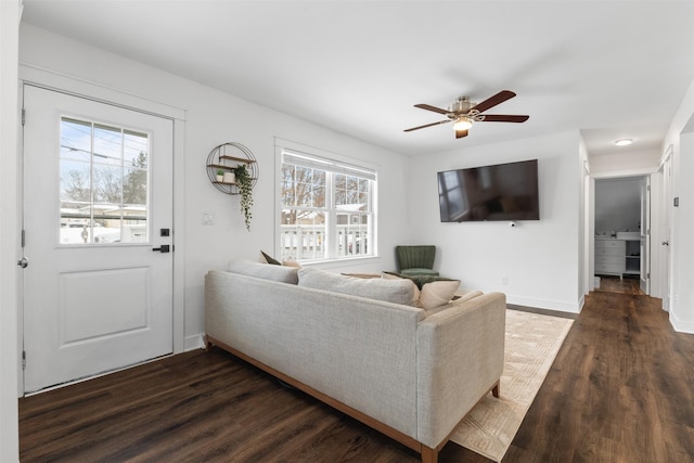 living room with dark hardwood / wood-style flooring and ceiling fan