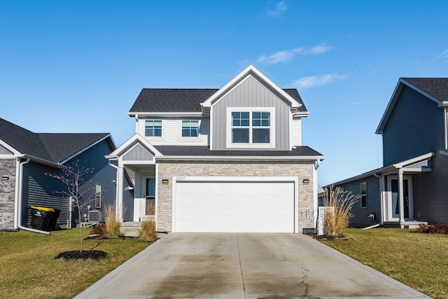 view of front of home featuring a front yard and a garage