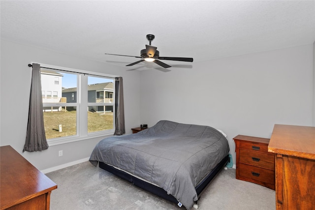 bedroom with light carpet and ceiling fan