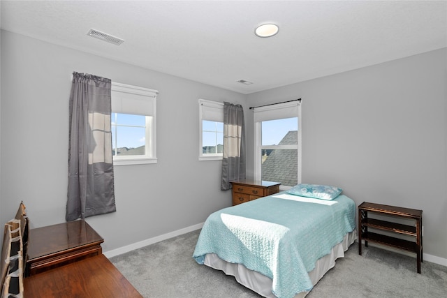 bedroom featuring light colored carpet