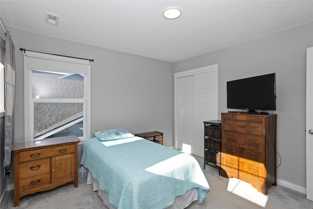 carpeted bedroom with a closet