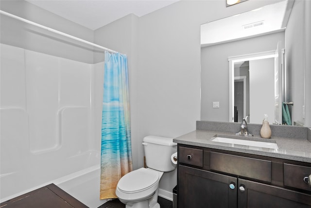 full bathroom with shower / bath combo, vanity, and toilet