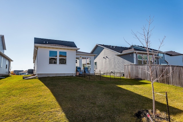 rear view of property featuring a yard