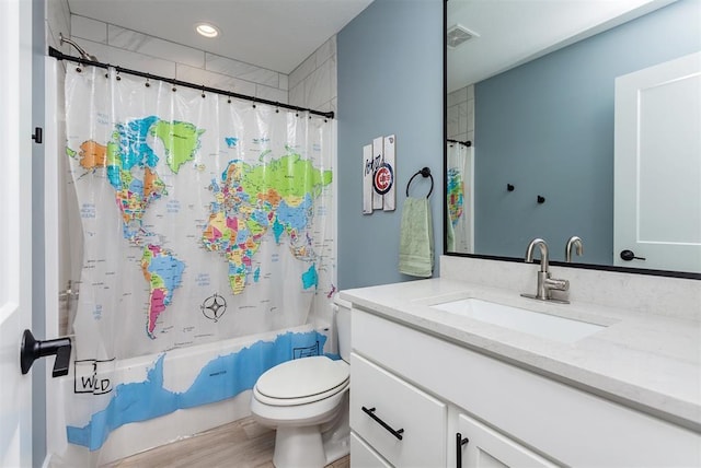 full bathroom featuring vanity, wood-type flooring, toilet, and shower / tub combo with curtain