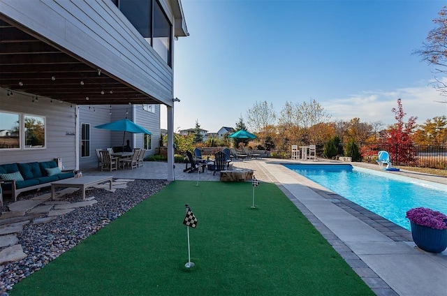 view of swimming pool with an outdoor living space and a patio area