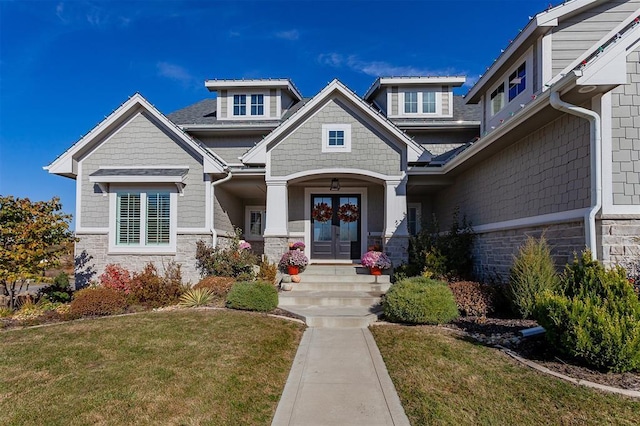 view of front of home with a front lawn and french doors