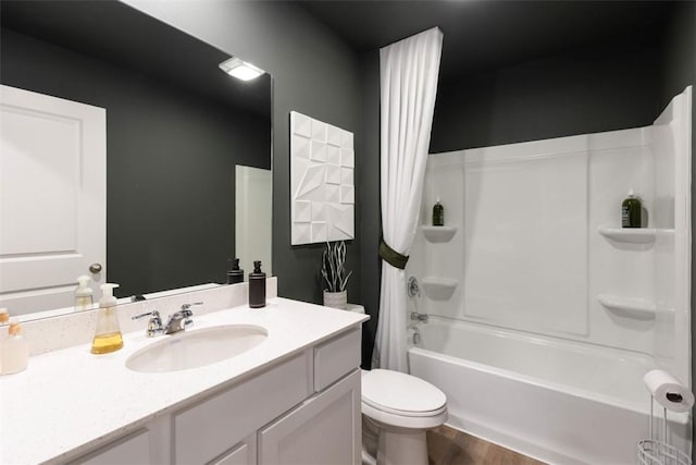 full bathroom with vanity, wood-type flooring, shower / tub combo, and toilet