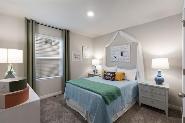 bedroom with baseboards and dark colored carpet