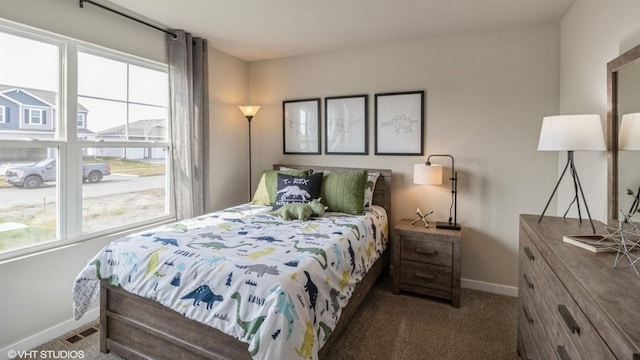 bedroom with multiple windows, carpet, visible vents, and baseboards