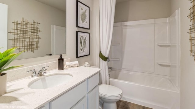 full bathroom featuring shower / tub combo, vanity, and toilet