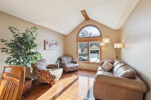 living room with vaulted ceiling with beams and hardwood / wood-style flooring